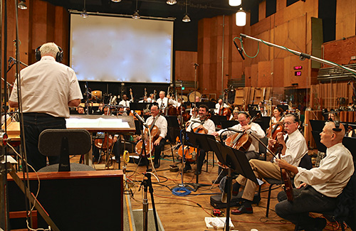 Conductor Tim Simonec instructs the orchestra during an \'Apes\' session on the Newman Scoring Stage at 20th Century Fox.
