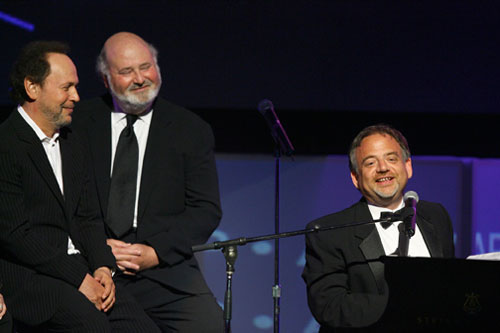 Billy Crystal and Rob Reiner barely contain their laughter as Shaiman 
